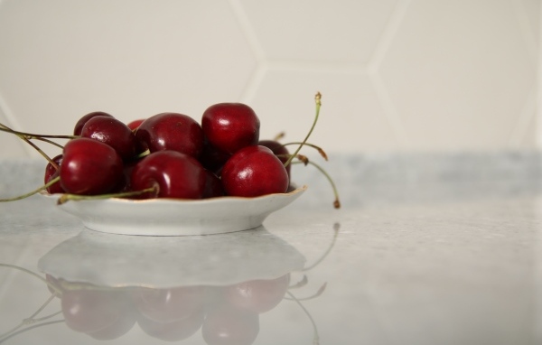 Вкусные сладкие черешни на белой тарелке