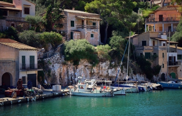 Лодки в воде у причала у домов