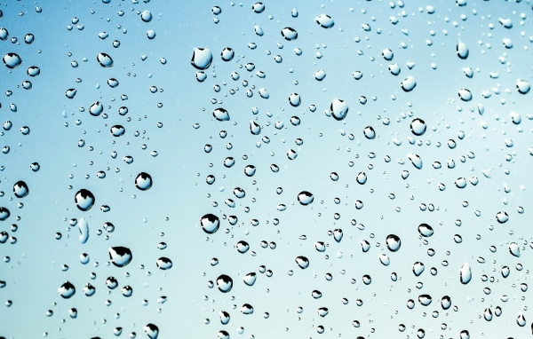 Капли дождя на голубом стекле