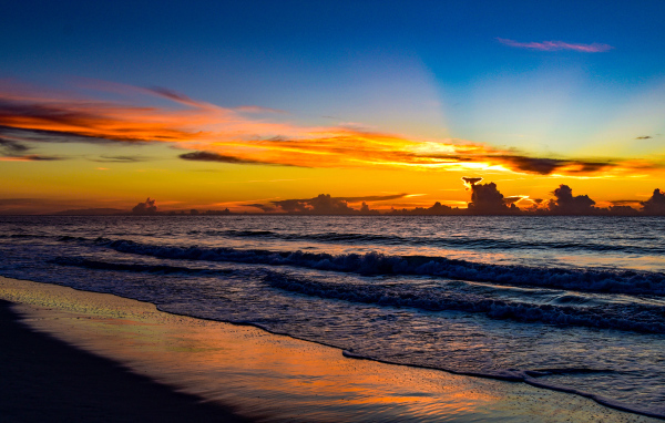 Яркие лучи солнца на закате над морем