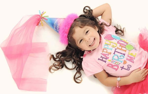 Девочка в костюме на день рождения на белом фоне