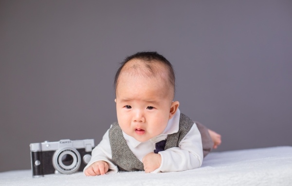 Маленький мальчик в костюме с фотоаппаратом