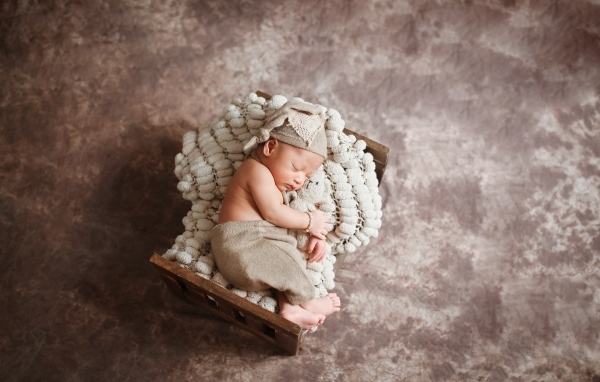 Спящий новорожденный ребенок в кроватке 