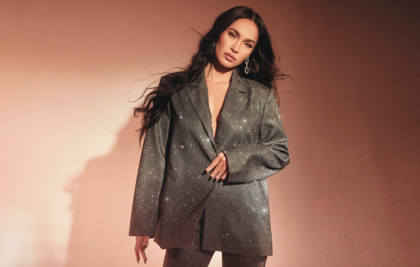 Актриса Меган Фокс в ярком костюме у стены