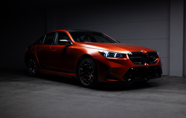 Красный автомобиль BMW M5 2025 года в гараже