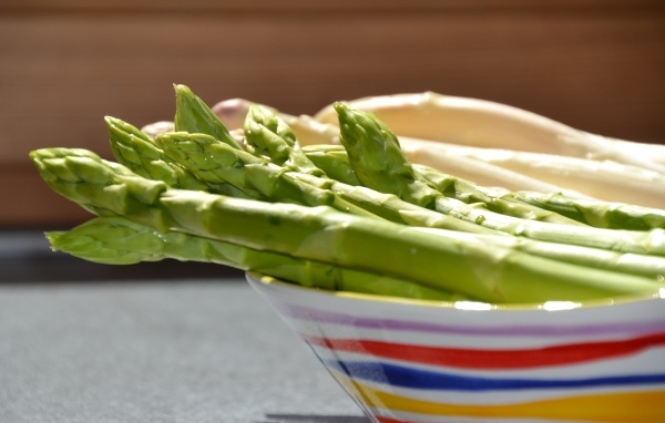 Зеленая спаржа в тарелке на столе