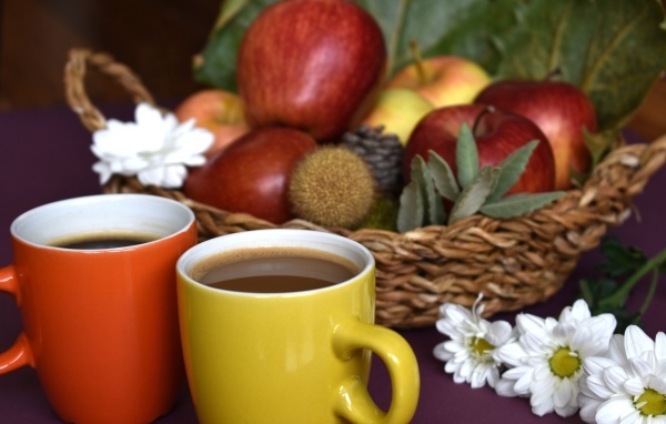 Две чашки кофе на столе с фруктами