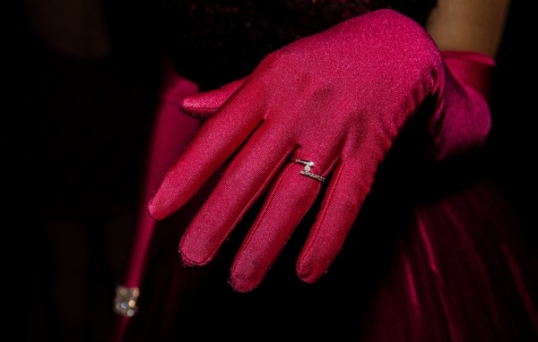 Женская рука с красной перчаткой и кольцом