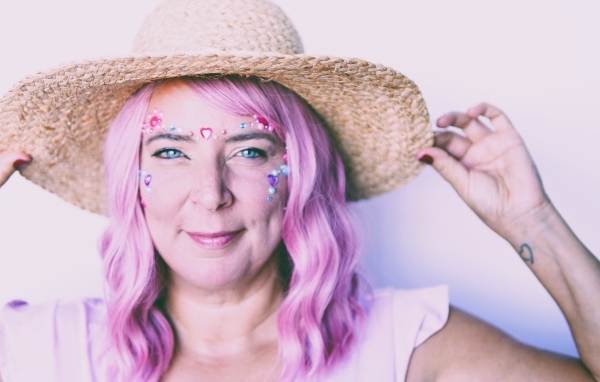 Женщина в шляпе с розовыми волосами