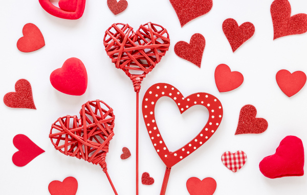 Плетеные и бумажные сердечки на белом фоне