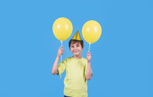 Мальчик на день рождения с желтыми шариками