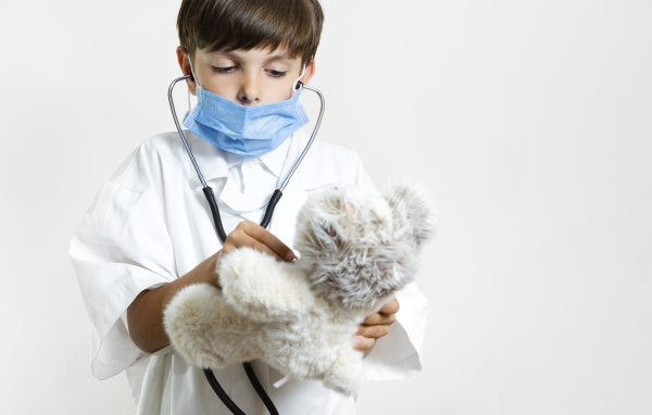 Мальчик в костюме врача с игрушечным медведем