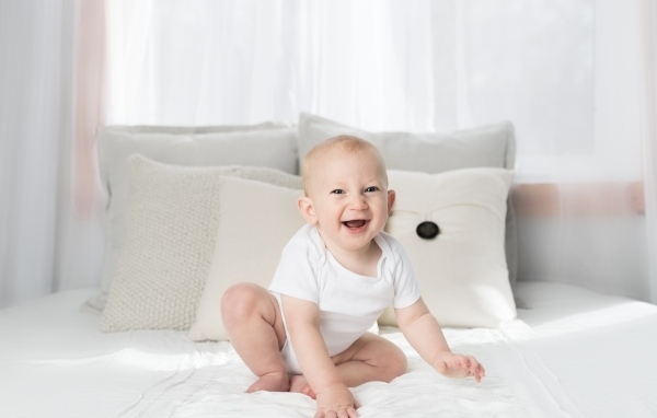 Смешной маленький ребенок на кровати