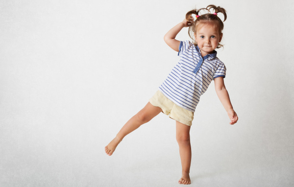 Маленькая девочка на сером фоне