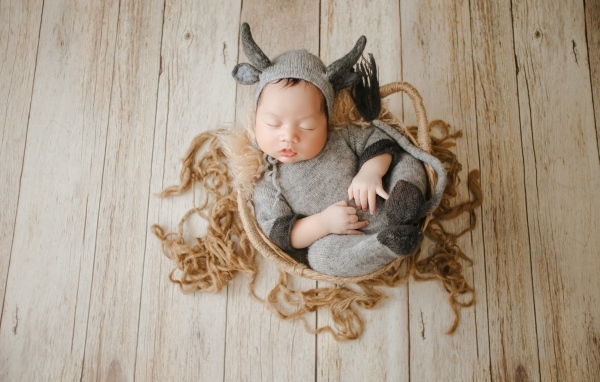 Маленький спящий ребенок в вязаном костюме