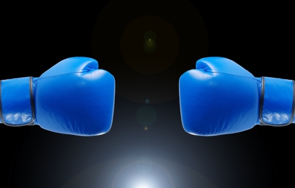 Синие боксерские перчатки на черном фоне