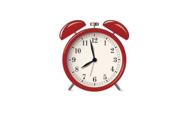 Красный будильник на белом фоне