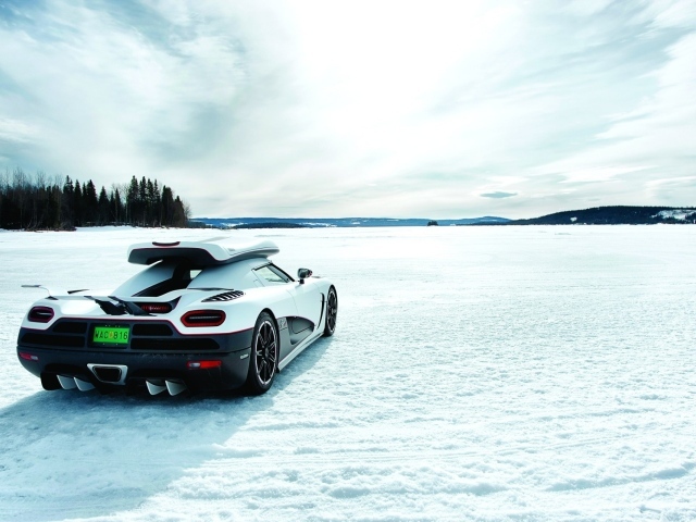 White Koenigsegg on a snow-covered field