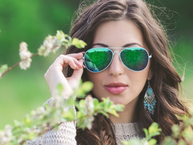 Green reflection of a girl with glasses
