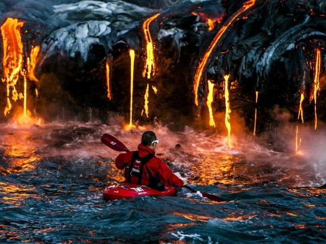 Man on the background of lava flowing into the sea