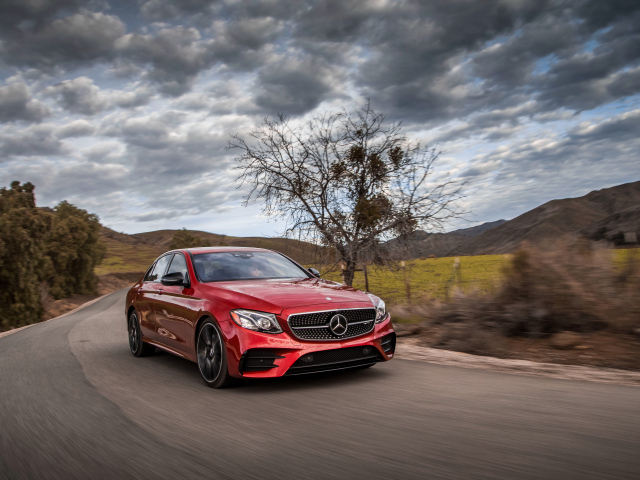 Stylish red Mercedes-Benz E-Class on the sky