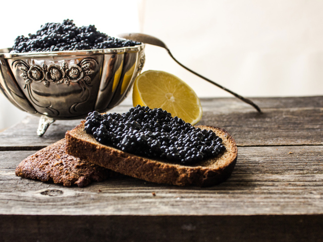 A slice of black bread with black caviar