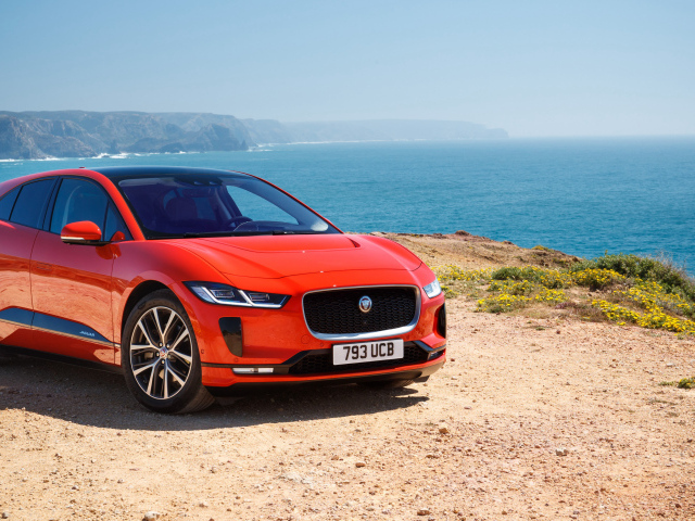 Red Jaguar I-Pace EV400 AWD HSE First Edition 2018 on the background of the ocean