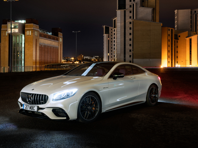 White car Mercedes AMG S 63 4MATIC Coupe, 2018 against the backdrop of the city