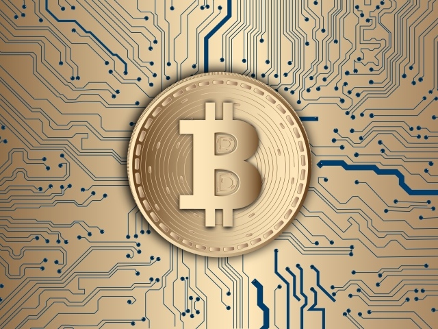 Coin bitcoin on an electronic board