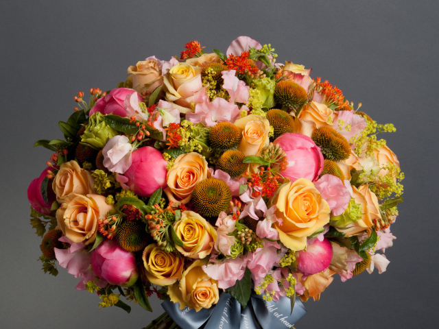Large beautiful bouquet of flowers on a gray background