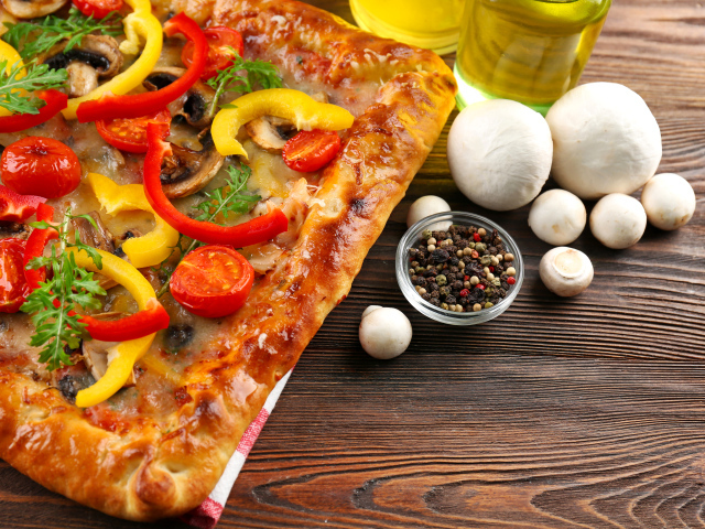 Appetizing pizza on the table with pepper and mushrooms