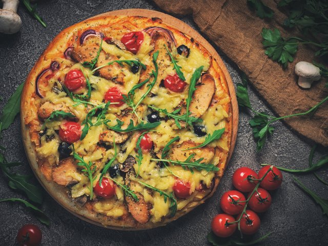 Пицца с томатами, сыром, мясом и зеленью рукколы 