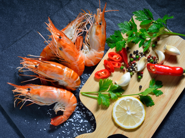 Boiled shrimps on the table with spices and herbs