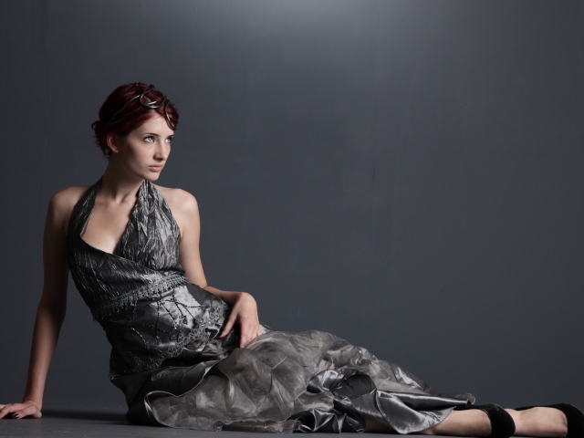 American model Susan Coffey in a beautiful dress on a gray background