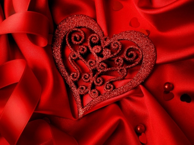 Brilliant heart on a red satin fabric