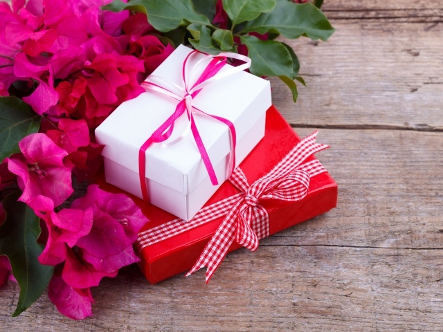 Две коробки с подарками на столе с цветами