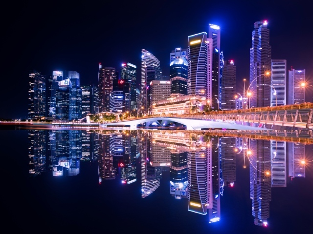 Night skyscrapers are reflected in the water, the city of Singapore, Asia