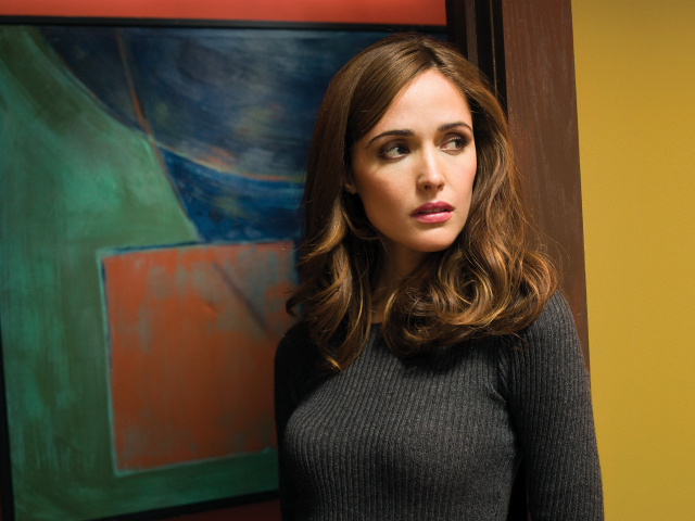 Actress Rose Byrne in a gray sweater against the wall