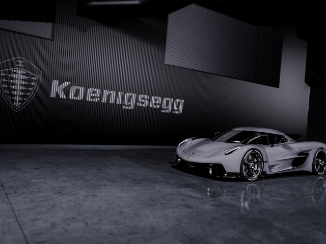 Спортивный автомобиль Koenigsegg Jesko Absolut 2020 года на фоне логотипа на стене