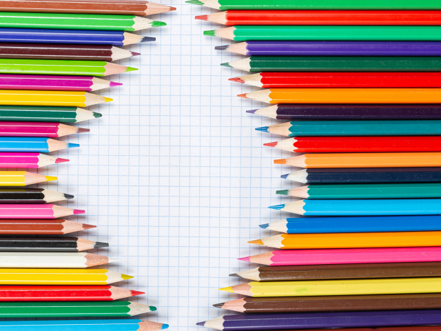 Sharpened multicolored pencils on a sheet of notebook