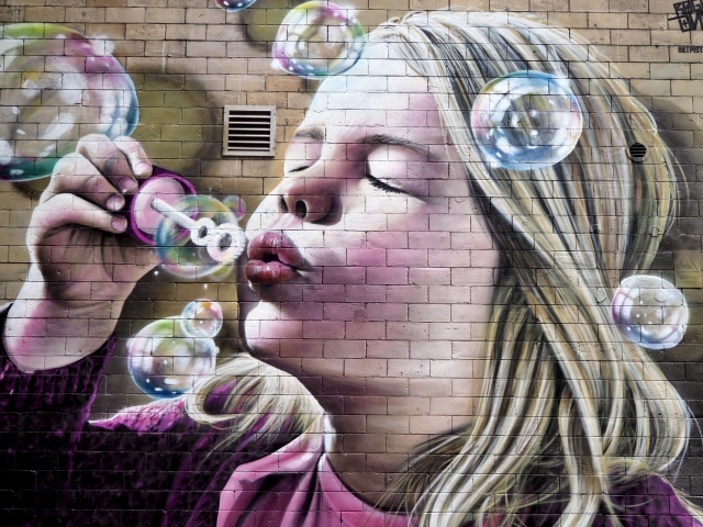 Girl with soap bubbles is painted on the wall.