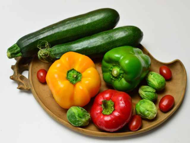 Sweet pepper, zucchini, tomatoes and brussels sprouts on a gray background