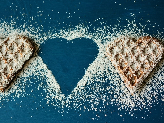 Heart shaped cookies sprinkled with icing sugar