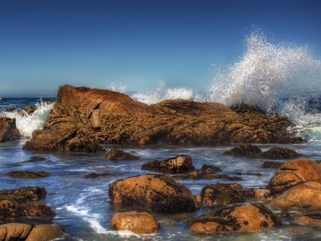 Stormy sea waves beat against stones