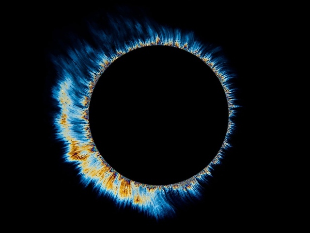 Solar eclipse with bright sparks on a black background