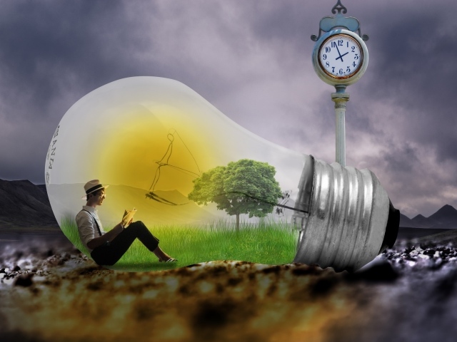 A man sits in a big fantastic light bulb by the clock