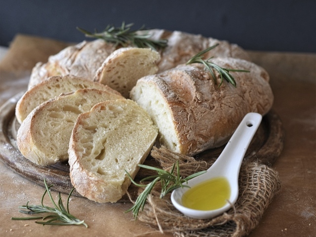 Fresh loaf on the table with rosemary and butter