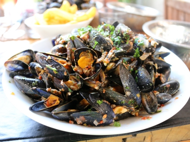 Mussels on a white plate with spices