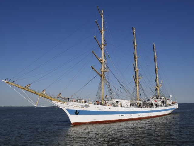 Large ship with lowered sails at sea