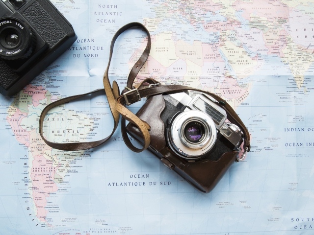 Old camera lies on the map